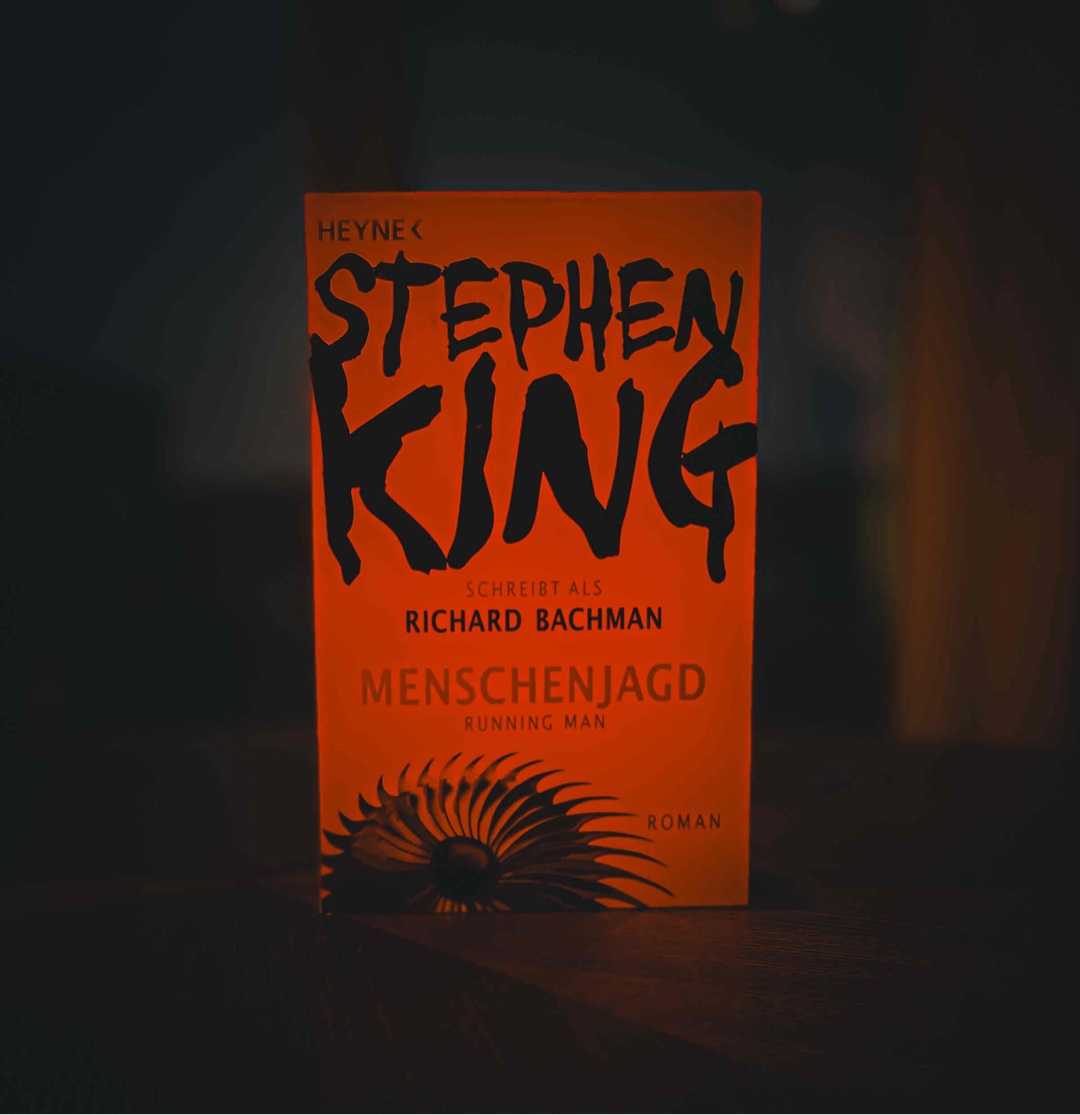 Wie so oft habe ich auch dieses Buch ohne grosse Recherche ausgewählt – und es hat mich sofort in seinen Bann gezogen. Eigentlich hatte ich ein klassisches Horrorbuch erwartet, aber «Menschenjagd» ist eher eine spannende Mischung aus «Die Tribute von Panem» und «1984». Der Roman, der 1982 geschrieben wurde und im Jahr 2025 spielt, entwirft ein düsteres Zukunftsbild. An einigen Stellen hätte ich mir etwas mehr Details gewünscht. Trotzdem kann ich das Buch allen empfehlen, die Dystopien mögen. 🏭🩸📹
